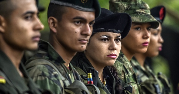 Members of the Revolutionary Armed Forces of Colombia stand during a ceremony at a camp in the Colombian mountains on Feb. 18, 2016.