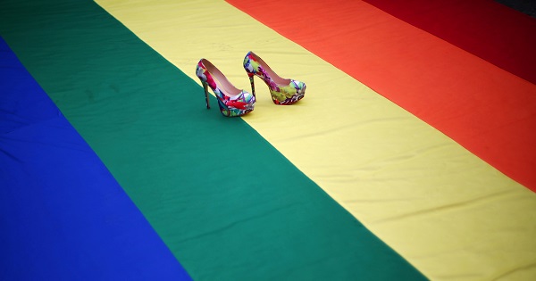 High heel shoes are seen on a rainbow flag during a protest by the LGBT community against violence against transgender people in Mexico City, Nov. 13, 2016.