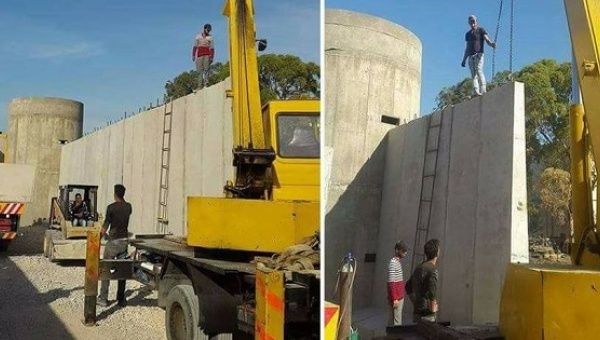 Construction workers and vehicles build a wall around Ain al-Hilweh Palestinian refugee camp near Sidon city in Lebanon.