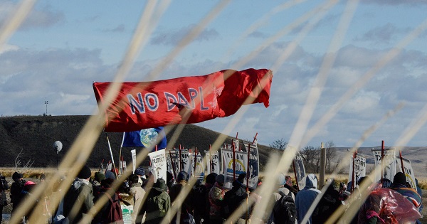 A banner is flown during a protest against plans to pass the Dakota Access pipeline near the Standing Rock Indian Reservation, North Dakota, U.S., Nov. 18, 2016.