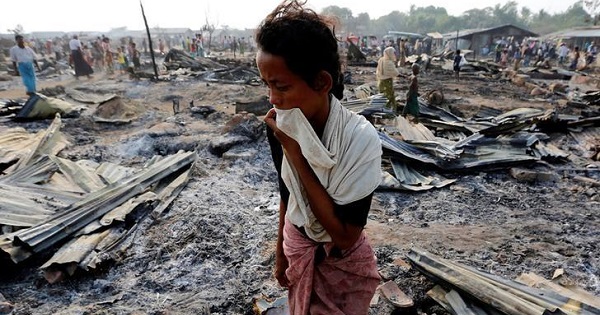 A woman walks among debris after fire destroyed shelters at a camp for internally displaced Rohingya Muslims in Rakhine State near Sittwe, Myanmar May 3, 2016.