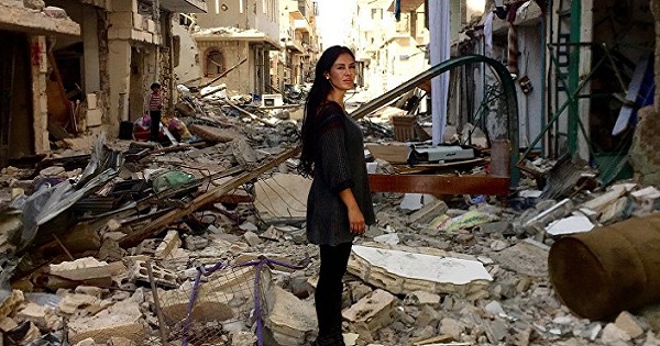 Carla Ortiz stands in war-torn Syria during filming of her upcoming documentary.