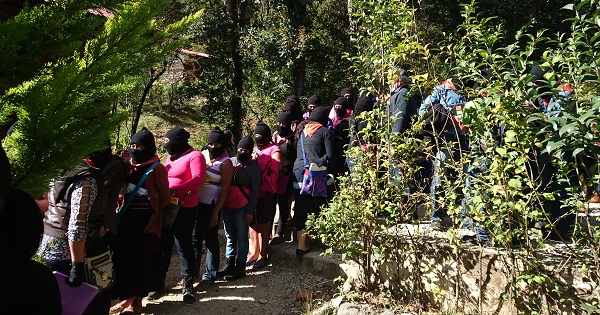 Zapatista women arrive at an information session.