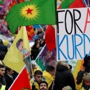 Members of the Kurdish community hold banner and flags during a rally in front of the Gare du Nord railway station in Paris, France, Jan. 7, 2017. 