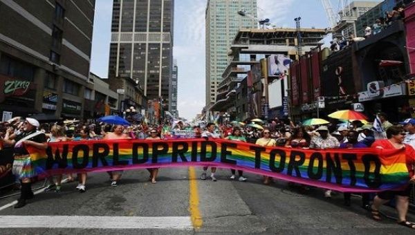 Marchers hold a banner as they participate in the Pride parade in Toronto, June 29, 2014. 