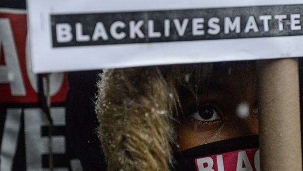 People participate in a Black Lives Matter protest in front of Trump Tower in New York City, U.S. Jan. 14, 2017.