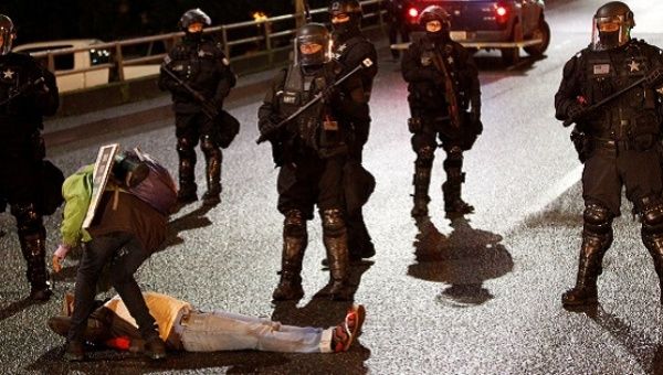 Police block entrance to a bridge as demonstrators protest the inauguration of U.S. President Donald Trump.