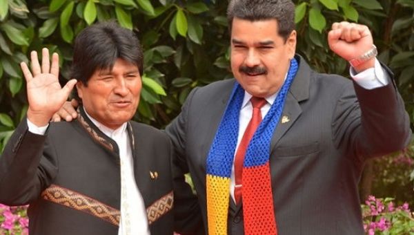 Bolivian President Evo Morales (L) gestures alongside his Venezuelan counterpart President Nicolas Maduro.