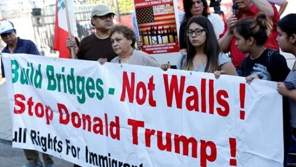 Protesters rally against Trump's immigration policies before his visit to Mexico prior to his election.