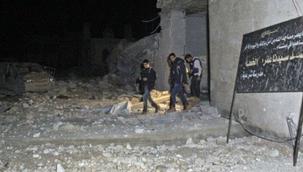 Rescuers emerge from a Mosque attacked in a U.S. bombing raid in the village of Al-Jineh, Syria. March 16, 2017