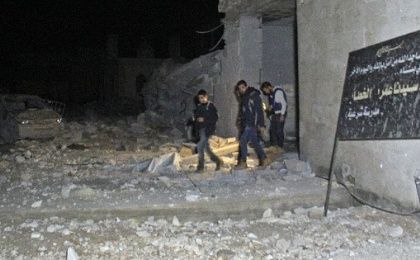 Rescuers emerge from a Mosque attacked in a U.S. bombing raid in the village of Al-Jineh, Syria. March 16, 2017