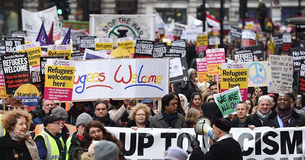 Tens of thousands of people march through central London during a 'Refugees Welcome' national protest in London, Britain, March 19, 2016.