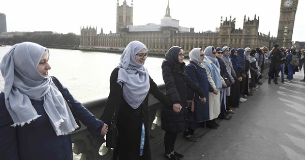 Muslim women hold hands to remember victims of the attack in Westminster that killed four people last Wednesday.