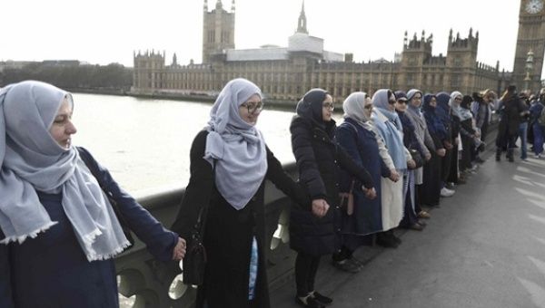 Muslim women hold hands to remember victims of the attack in Westminster that killed four people last Wednesday.