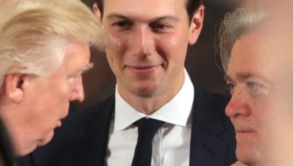 U.S. President Donald Trump talks to senior staff Steve Bannon and Jared Kushner at the White House in Washington, D.C. 