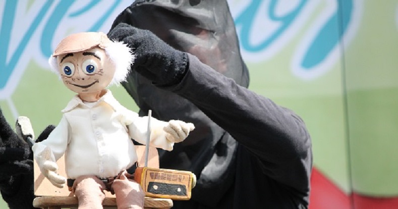 A puppeteer performs with one of a cadre of 10 puppets.