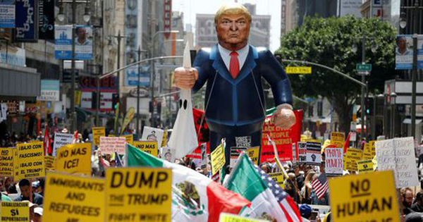 A gigantic Trump effigy is carried down the street during a protest in Los Angeles, CA.
