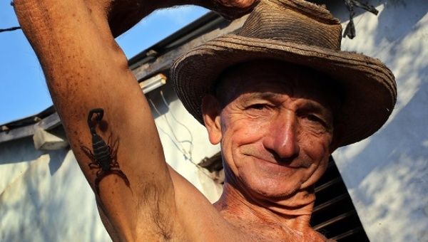 Pepe Casañas poses with a scorpion in the town of Los Palacios in Cuba's far western province of Pinar del Rio on March 29, 2017.