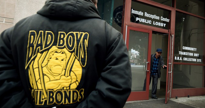 A man in a Bad Boys Bail Bonds jacket waits outside the Sheriff's Department Inmate Reception Center in Los Angeles, Calif. on Jan. 30, 2015.