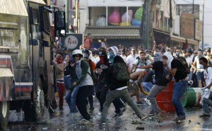 Opposition demonstrators throw stones at Venezuelan police during a violent right-wing protest in Caracas.