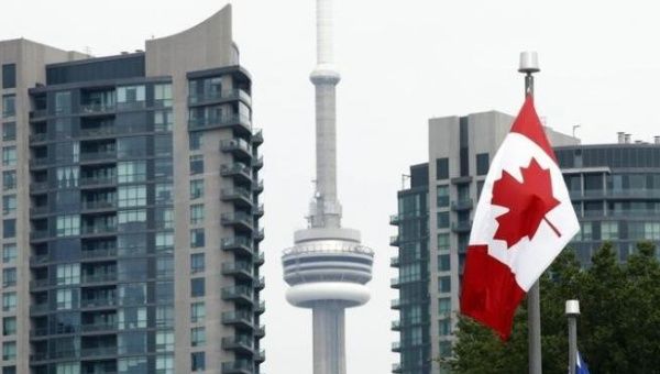 A general of a Canadian flag on Princes' Boulevard with the CN Tower in the background. (File)