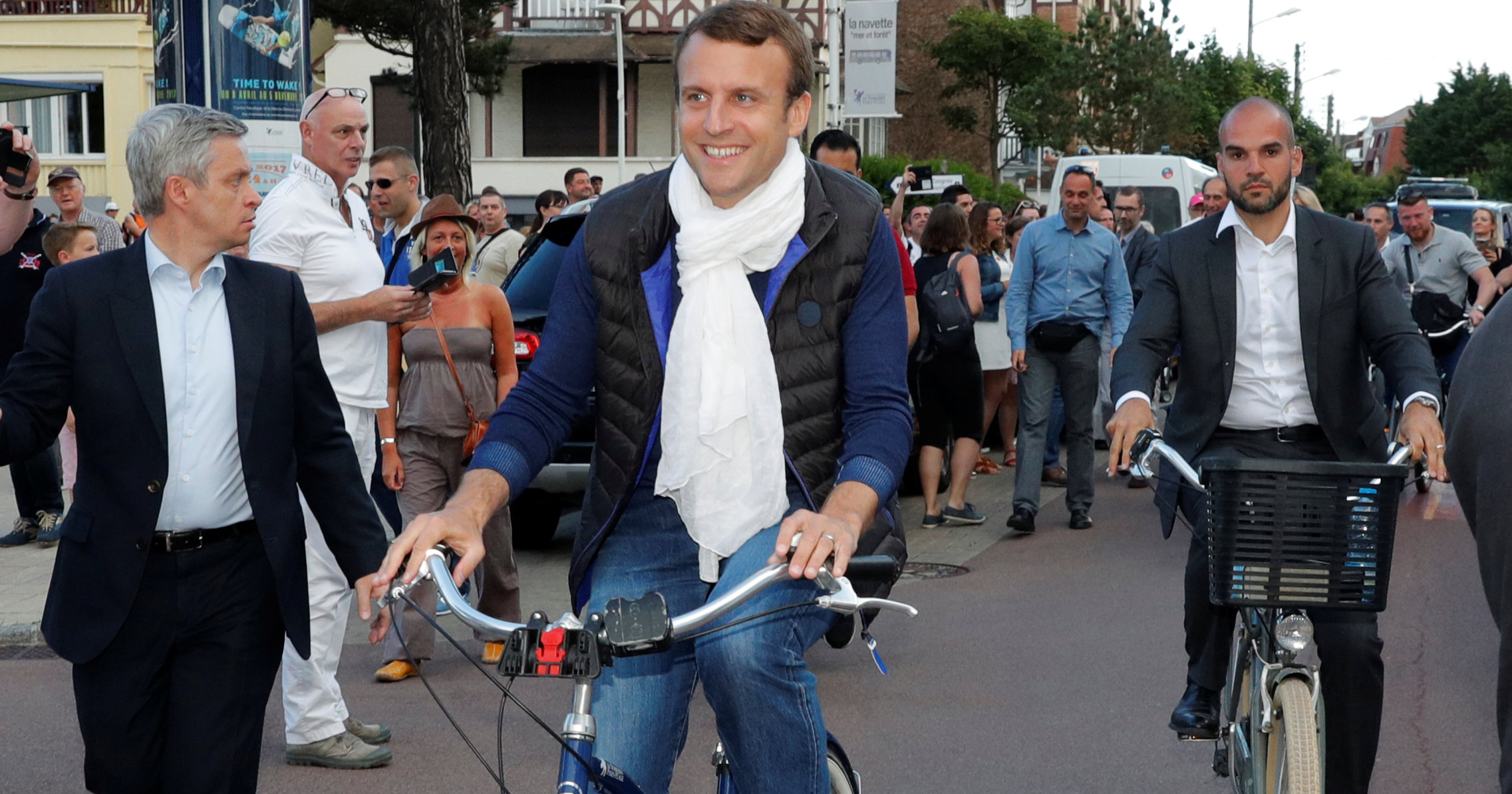 French President Emmanuel Macron rides a bicycle in Le Touquet, France, on the eve of the first round of the parliamentary election, June 10, 2017.