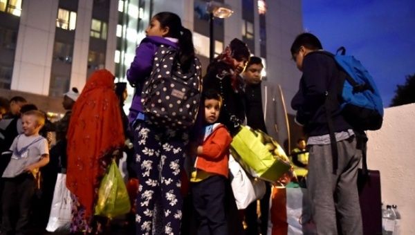 Residents are evacuated from a residential block as a precautionary measure on the Chalcots Estate in north London, UK, June 23, 2017. 