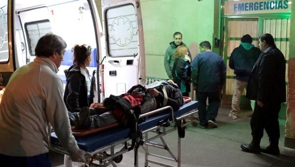 A injured man is carried into the emergency room at Schestakow Hospital in San Rafael, Argentina.