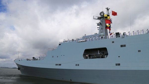 Soldiers of China's People's Liberation Army salute from a ship sailing off from a military port in Zhanjiang, China, on July 11, 2017. 