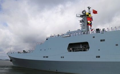 Soldiers of China's People's Liberation Army salute from a ship sailing off from a military port in Zhanjiang, China, on July 11, 2017. 