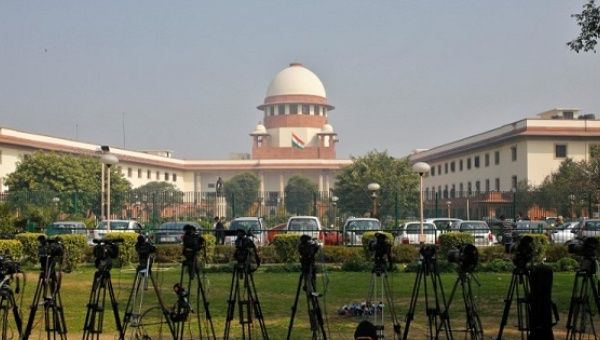  A television journalist sets his cameras inside the premises of the Supreme Court in New Delhi, India, on February 18, 2014. 