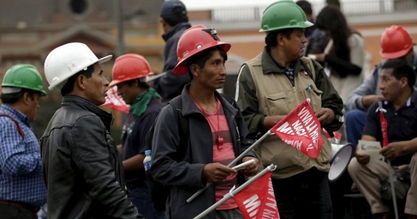 Miners hold signs during a national strike in Lima, Peru, May 21, 2015.