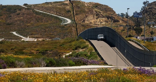 U.S. border patrol agents at the fence with Mexico at Border Field State Park in San Diego, California.