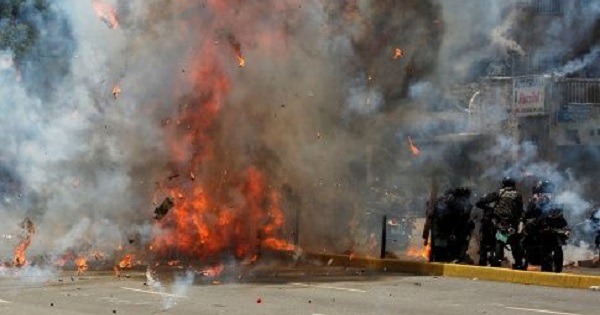 An explosion injured seven police officers and burnt four motorcycles on Sunday.