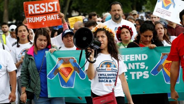 Demonstrators carrying signs march during a rally in Washington, U.S., August 15, 2017. 