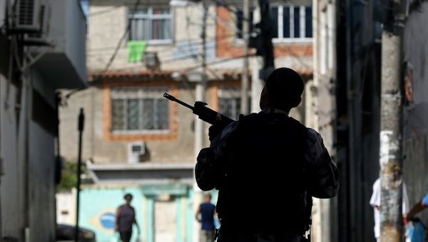 A police officer stands guard during a raid on the City of God favela, Rio de Janeiro, Brazil, November 20, 2016