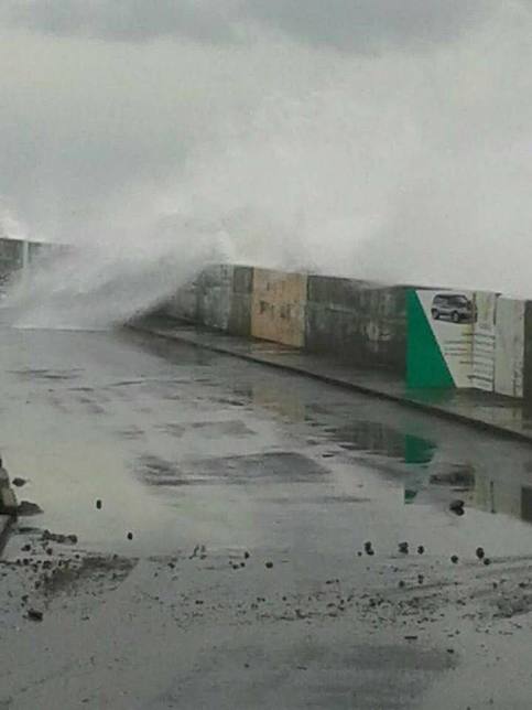 Choppy waters in Marigot, Dominica breach the sea wall and spill into the streets.