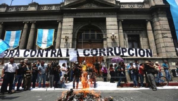 Demonstrators protest outside the Congress against a new law that shields senior party leaders from prosecution for campaign-financing violations, in Guatemala City, Guatemala on Sept. 14, 2017.