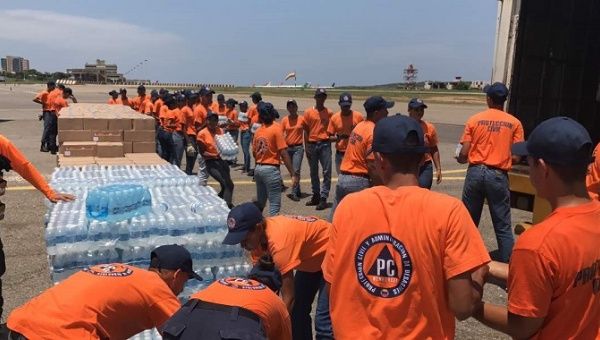 An aid plane is being loaded in Caracas for Dominica which was badly hit by Hurricane Maria.