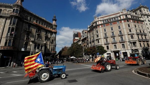 Farmers drive their tractors through Barcelona streets in support of Catalonia's independence vote. 