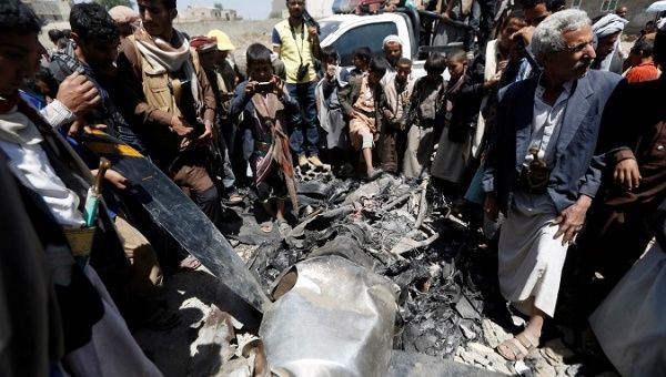 People gather around the engine of a drone aircraft which the Houthi rebels said they have downed in Sanaa, Yemen Oct. 1, 2017.