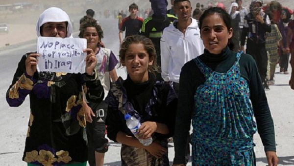 Displaced people from the minority Yazidi sect, who fled the violence in the Iraqi town of Sinjar, march in a demonstration at the Iraqi-Turkish border.