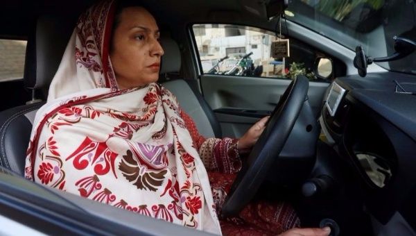 Careem captain Aasia Abdul Aziz drives her car in Karachi, Pakistan, Dec. 6, 2016. 