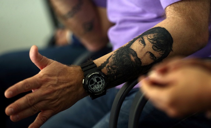 Sergio Maldonado, brother of Santiago, shows a tattoo of his brother during a news conference.