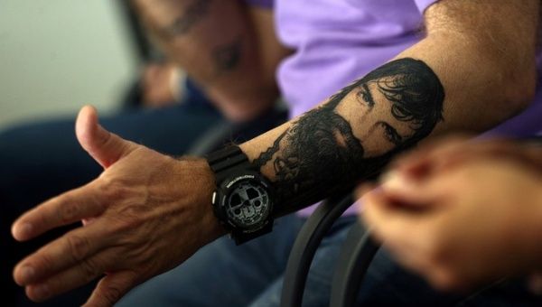 Sergio Maldonado, brother of Santiago, shows a tattoo of his brother during a news conference.