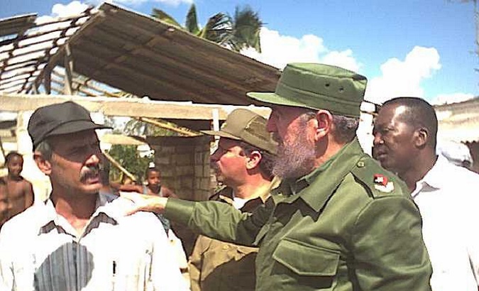 Cuban leader Fidel Castro with workers after Hurricane Ivan hit the island in 2004.