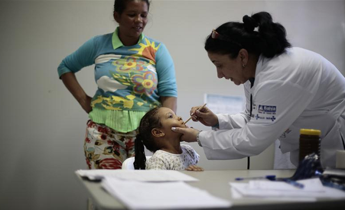 Cuban doctor Dania Rosa Alvero Pez examines a young patient at the Health Center in the city of Jiquitaia in the state of Bahia, north-eastern Brazil.