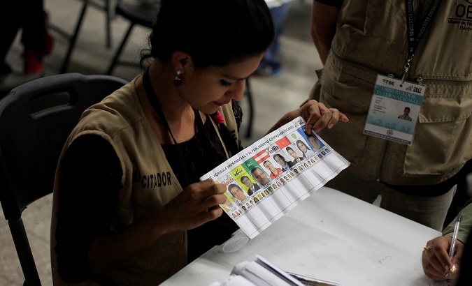 Scrutineers re-count ballots of the general election during a partial re-count in presidential vote in Tegucigalpa.