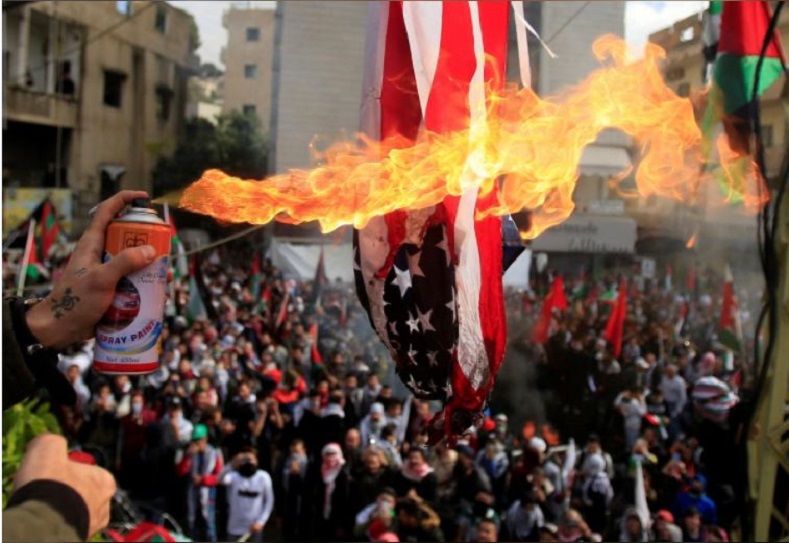 Protesters in Lebanon set the American flag aflame just blocks from the U.S. embassy in Awkar, Lebanon December 10.