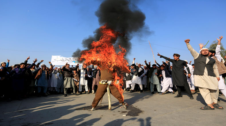 Afghan protesters set fire to an effigy of US President Donald Trump during a demonstration against the change of policy regarding Jerusalem.